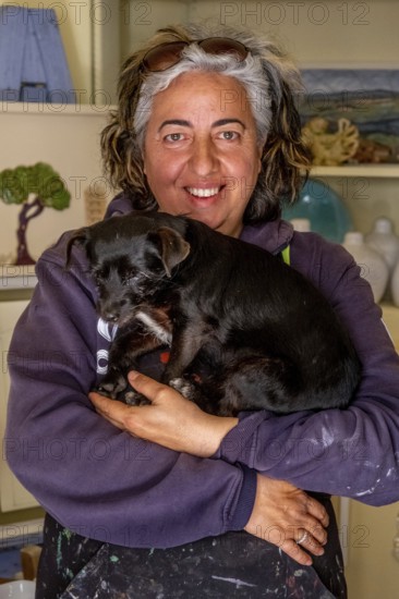 Sardinia, Pina Monne, female portrait and dog on arm, artist, Tinnura, Europe, Oristano province,