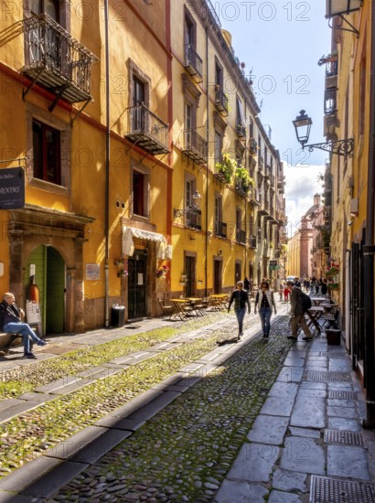 Sardinia, tourists in a pedestrian zone with picturesque house fronts, Bosa, Europe, Province of