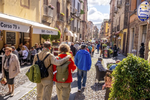 Sardinia, tourists in a pedestrian zone, stroll of tourists on a shopping street, Bosa, Europe,