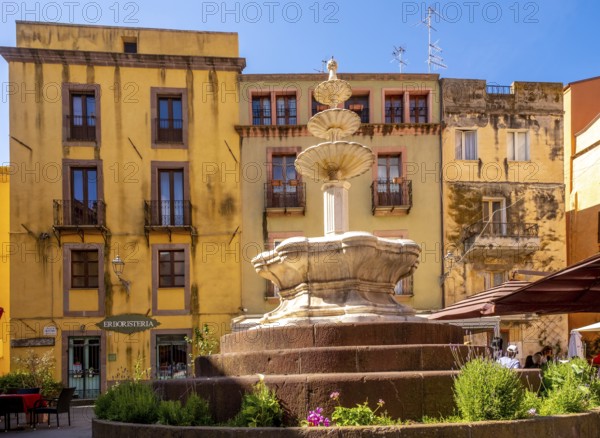 Sardinia, artistic fountain with three levels on the Piazza Costituzione, house wall with