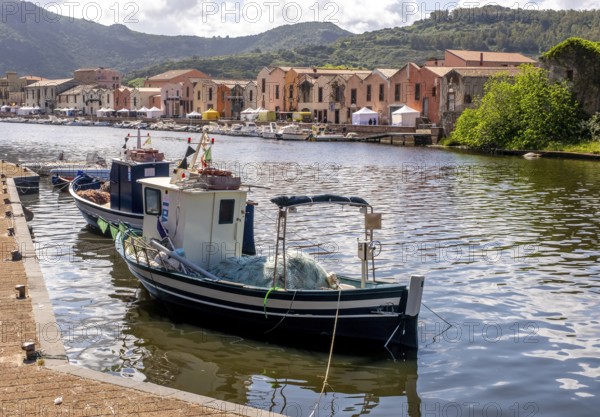 Sardinia, fishing boat in the harbour of Bosa, harbour mile promenade with pavilions and boats on