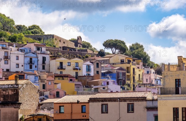 Sardinia, picturesque view of Bosa with pavilions on the promenade, residential buildings and