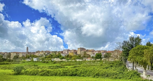 Sardinia, town view, town wall and church tower of Thiesi, blue sky with clouds, Thiesi, Europe,
