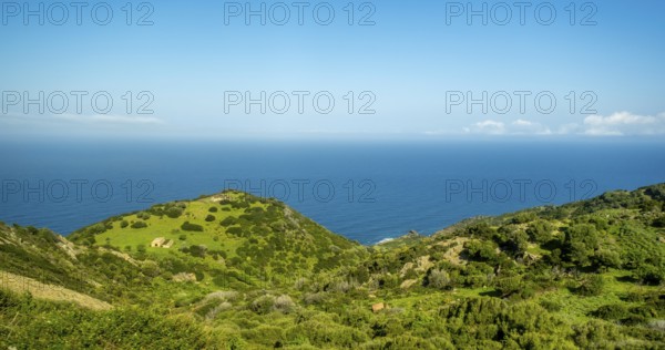 Sardinia, Mountainous coastal landscape by the sea, blue sky with clouds, Bosa, Europe, Province of