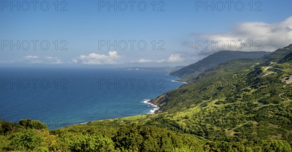 Sardinia, Mountainous coastal landscape by the sea, blue sky with clouds, Bosa, Europe, Province of