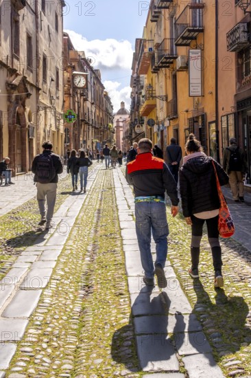 Sardinia, tourists in a pedestrian zone, artistic balconies and flower arrangements, Bosa, Europe,