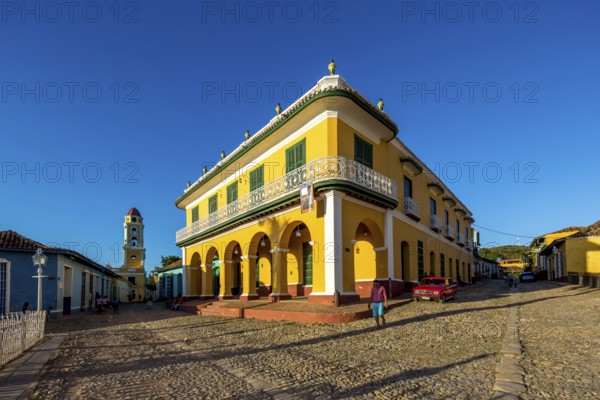 Centre of Trinidad Palacio Brunet, yellow palace with blue sky and the church Convento de San