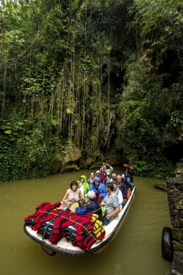 Exit of the cave system, tourists in an electric boat with life jackets, caves of the Indios, Cueva