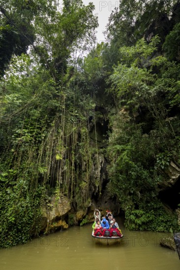 Exit of the cave system, tourists in an electric boat with life jackets, caves of the Indios, Cueva