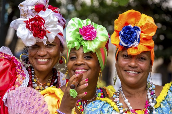 Three Cuban beauties on the streets of Old Havana in their colourful Spanish-inspired costumes, La