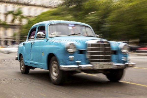 Speed, blurred, driving old car, blue Mercedes vintage car in street scene, old American road