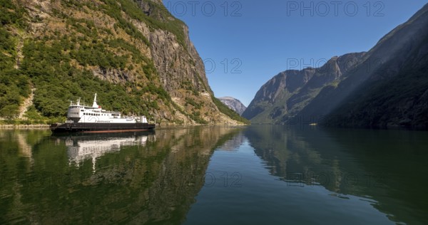 Excursion ship on a fjord, Flåm, Gudvangen, rock walls, trees, blue sky, Sogn og Fjordane, Norway,