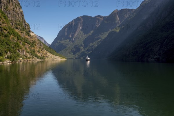Excursion ship on a fjord, Flåm, Gudvangen, rock walls, trees, blue sky, Sogn og Fjordane, Norway,
