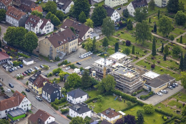 Aerial view, construction site with new building on the main road at the cemetery, left Städt. Kita