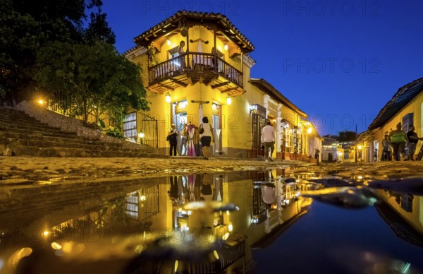 Restaurant and pub in the old town of Trinidad with visitors during the blue hour, Trinidad, Cuba,