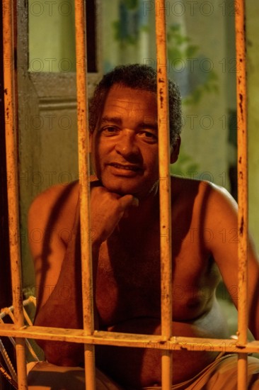 Paid car guards behind their barred windows in the old town of Trinidad, Street scene in the old