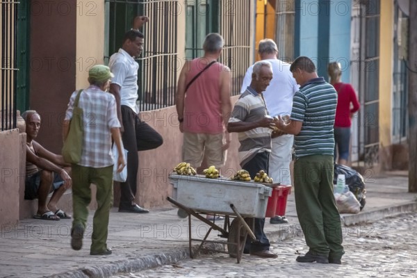Banana vendor with his stall on the street, Street scene in the old town of Trinidad, Trinidad,