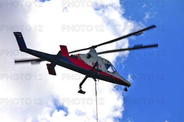 Helicopter in flight in the blue sky, transport helicopter, timber transport, Saas Grund, Canton