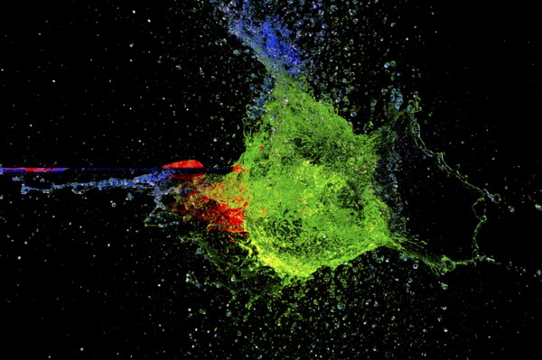 A vivid, explosive clash of green and red as an arrow pierces a water balloon, high-speed shot,