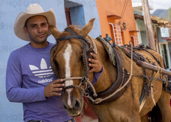 Cuban rider cowboy with his horse in the streets of Trinidad, Trinidad, Cuba, Sancti Spíritus,