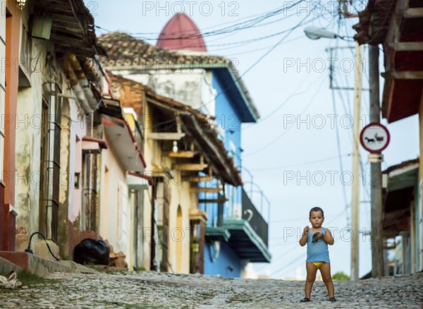 Little boy with nappies standing on the street, street scene in the old town of Trinidad, Trinidad,