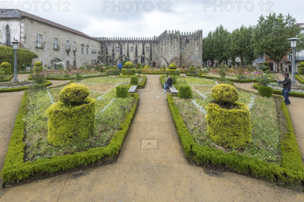 Jardim de Santa Barbara borders the crenellated facade of Antigo Paco Episcopal, former