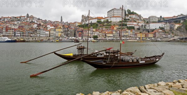 Historic wine transport ships on the Douro, colourful houses on the banks of the Douro in the