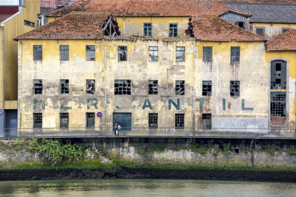 Old warehouse on the Douro, decay, labelling Mercantil, Oporto, Porto district, Portugal, Europe,
