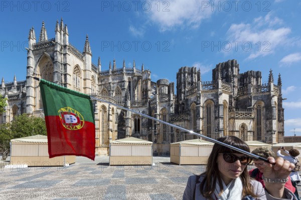 Travel guide in front of the monastery, Monastery of Santa Maria da VitÃüria, UNESCO World Heritage