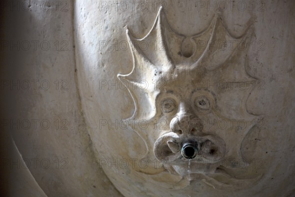 Devil's grimace on a fountain in the cloister, Monastery of Santa Maria da VitÃüria, UNESCO World