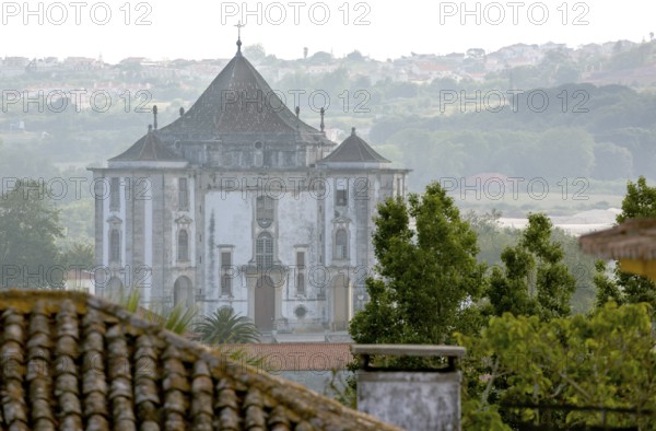 Picturesque small town of Obidos, view of the church in front of the city walls of Óbidos, Leiria