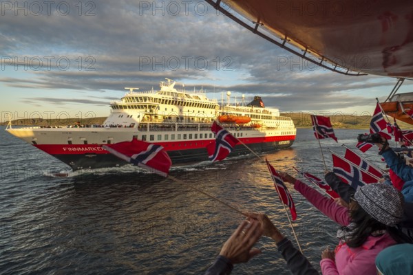 Tourists at the ship's railing, ship MS Finnmarken, Norwegian flags, Mehamn, Finnmark, Norway,