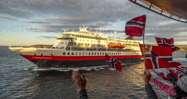 Tourists at the ship's railing, ship MS Finnmarken, Norwegian flags, Mehamn, Finnmark, Norway,
