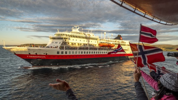 Tourists at the ship's railing, ship MS Finnmarken, Norwegian flags, Mehamn, Finnmark, Norway,
