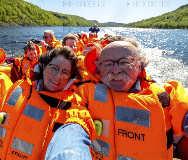 Selfie, tourists with life jackets, river trip with tourists on an excursion boat in a headwind,