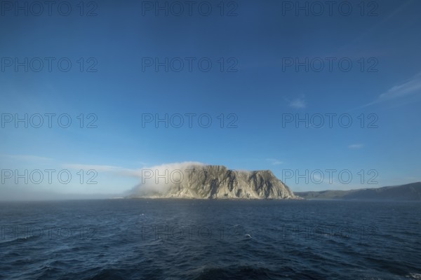 Island in the fog, Kjøllefjord, Finnmark, Norway, Scandinavia, Europe, adventure travel, tourism,