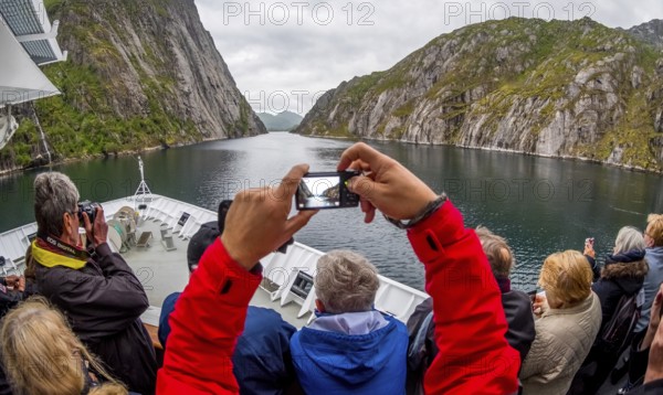 Cruise in a fjord, ship bow, photographing tourists, Digermulen, Nordland, Norway, Scandinavia,