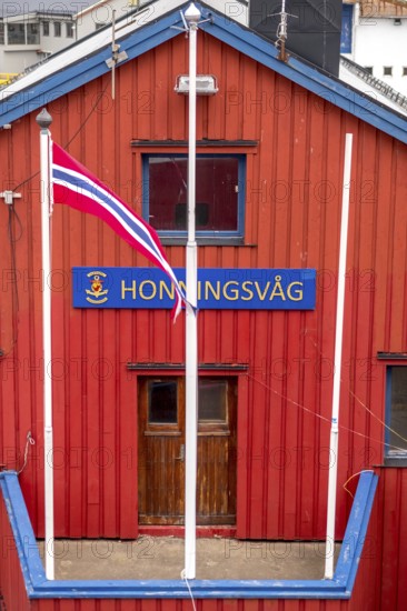 Red Norwegian house with town sign, Måsøy, Finnmark, Norway, Scandinavia, Europe, adventure trip,