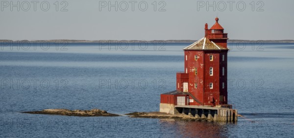 Kjeungskjær Fyr, red lighthouse, off the Norwegian coast on a small archipelago off Ã˜rland,