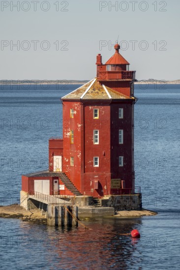Kjeungskjær Fyr, red lighthouse, off the Norwegian coast on a small archipelago off Ã˜rland,