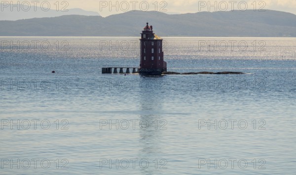 Kjeungskjær Fyr, red lighthouse, off the Norwegian coast on a small archipelago off Ã˜rland,