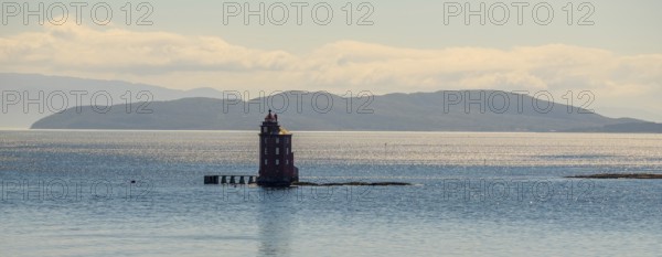Kjeungskjær Fyr, red lighthouse, off the Norwegian coast on a small archipelago off Ã˜rland,