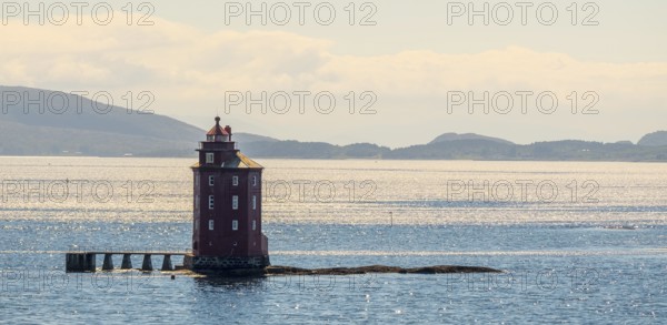 Kjeungskjær Fyr, red lighthouse, off the Norwegian coast on a small archipelago off Ã˜rland,