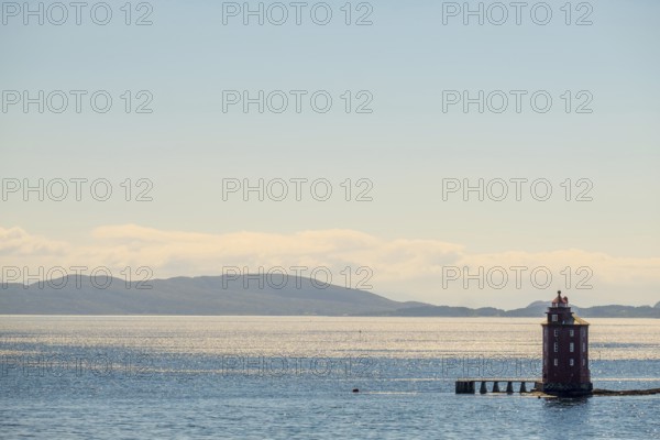 Kjeungskjær Fyr, red lighthouse, off the Norwegian coast on a small archipelago off Ã˜rland,
