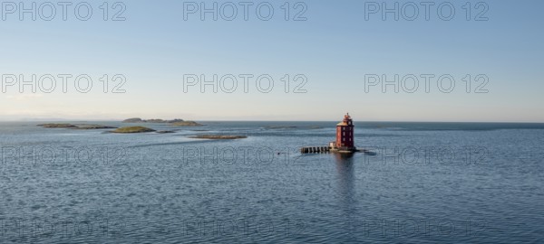 Kjeungskjær Fyr, red lighthouse, off the Norwegian coast on a small archipelago off Ã˜rland,