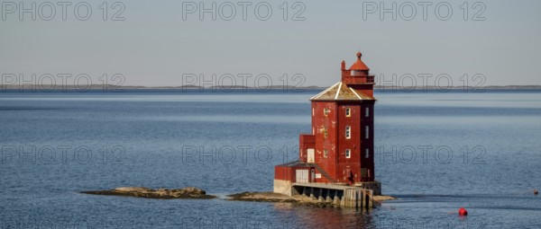 Kjeungskjær Fyr, red lighthouse, off the Norwegian coast on a small archipelago off Ã˜rland,