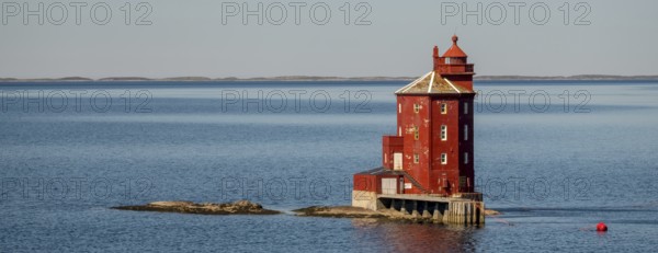 Kjeungskjær Fyr, red lighthouse, off the Norwegian coast on a small archipelago off Ã˜rland,