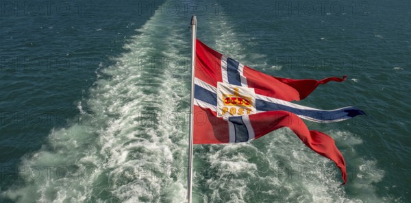 The post symbol on Norwegian flag of a Hurtigruten ship, foaming spray, Trondheimfjord, Agdenes,