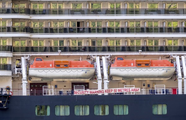 Ship RMS Queen Elizabeth, warning to sea pirates, security warning keep 50 metres away, lifeboats,