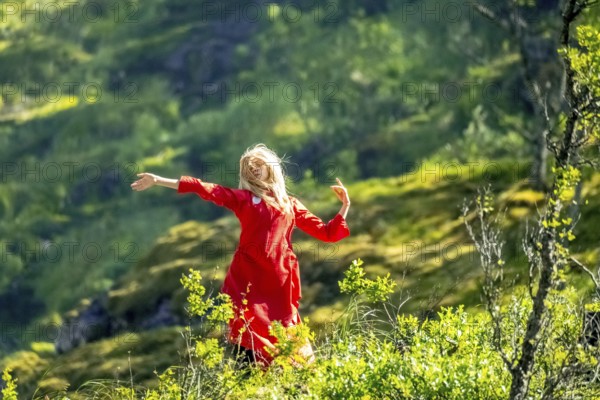 Woman dressed in red is a Huldra, fairy, legendary figure, Kjosfossen waterfall, waterfall near